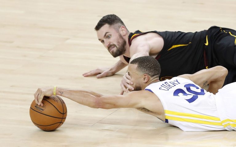Basketball Player Holds Opponent by the Face